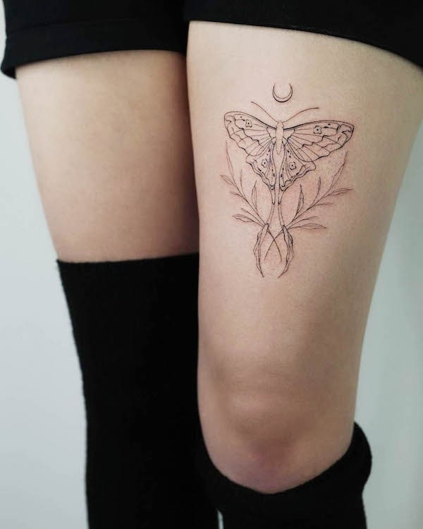 Luna moth and moon thigh tattoo by @akkurat_tattoo_studio