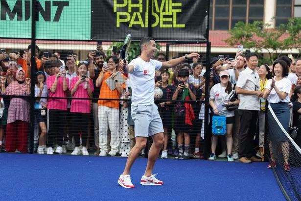 Portuguese football player Cristiano Ronaldo reacts as he hits a padel ball during an event to support youth scholarships founded by philanthropist Peter Lim in Singapore on June 3, 2023.