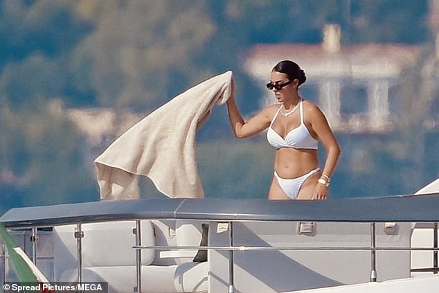 Georgina was seen waving her towel around as she dried off in the sunshine