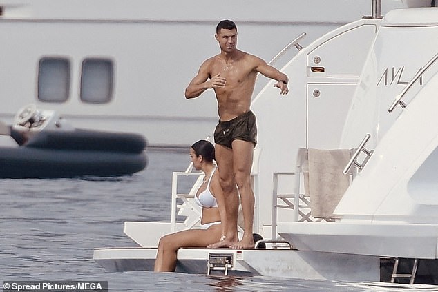 Ronaldo, 39, showed off his washboard abs and fit physique in khaki swimming trunks