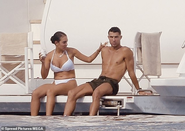 Georgina lovingly placed her hand on Ronaldo as they enjoyed a chat on the deck