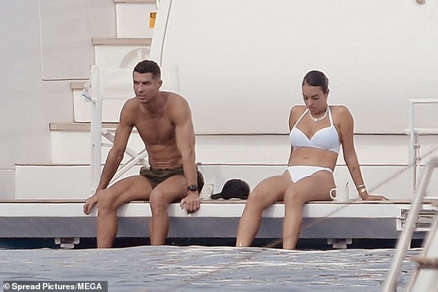 The couple looked in good spirits as they soaked up the sunshine, showcasing their enviably toned figures in skimpy swimwear