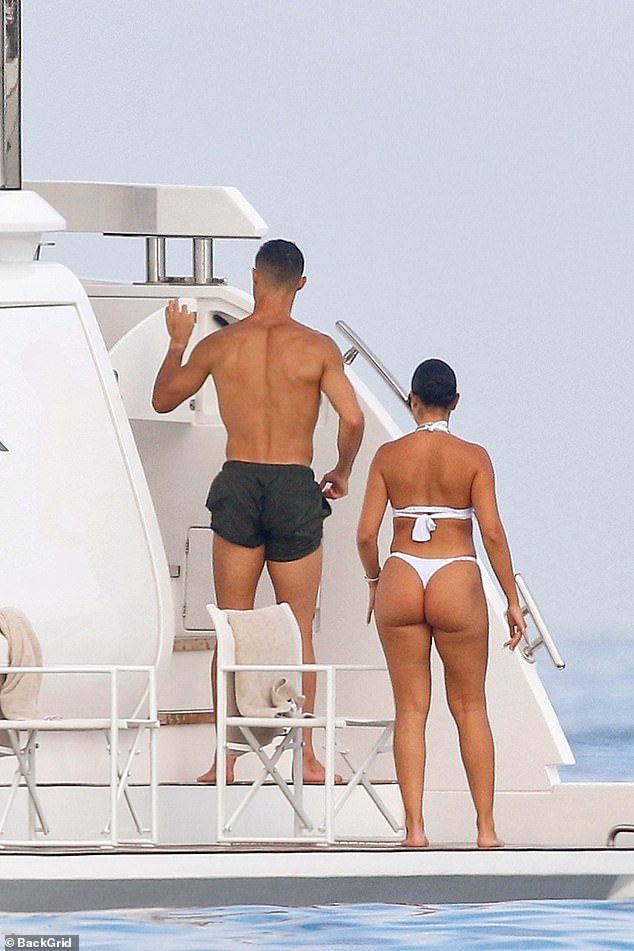 Georgina put on a cheeky display in the white thong halterneck bikini